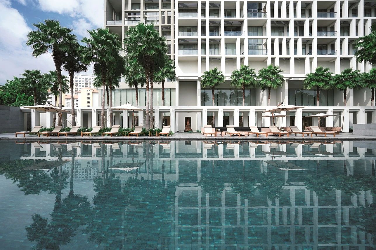 Pool terrace and white facade at The Sukhothai Residences