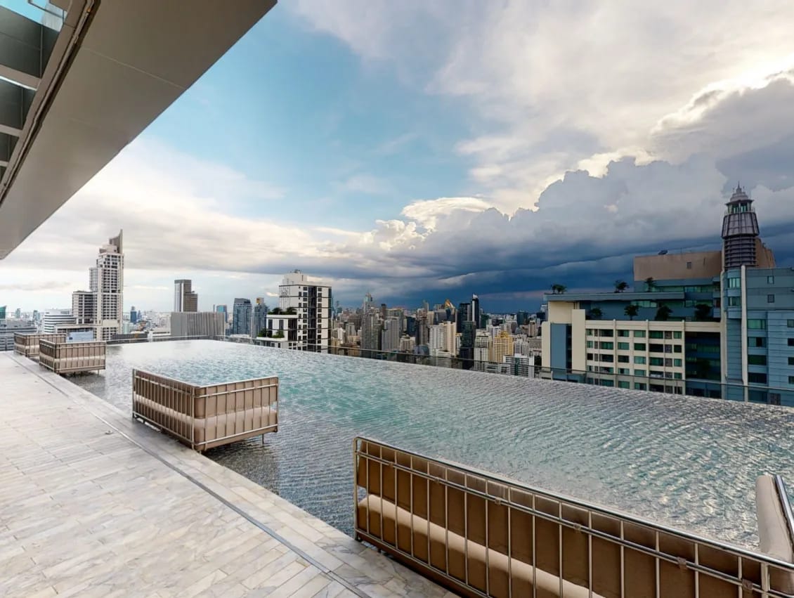 Infinity-edge pool and Bangkok skyline at The Esse at Singha Complex