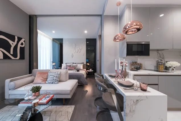 Illustrative show apartment living area and kitchen at The Esse at Singha Complex