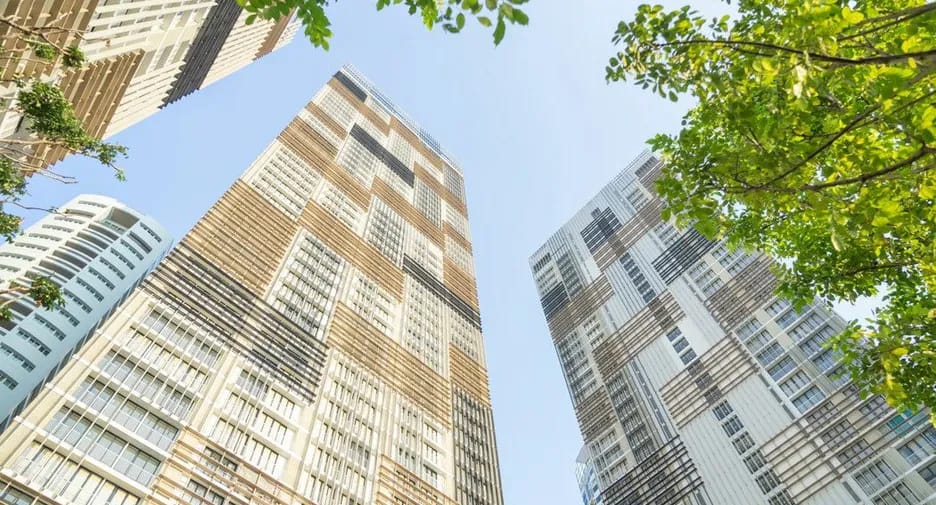 Park Origin Phrom Phong residential towers framed by trees on Sukhumvit 24